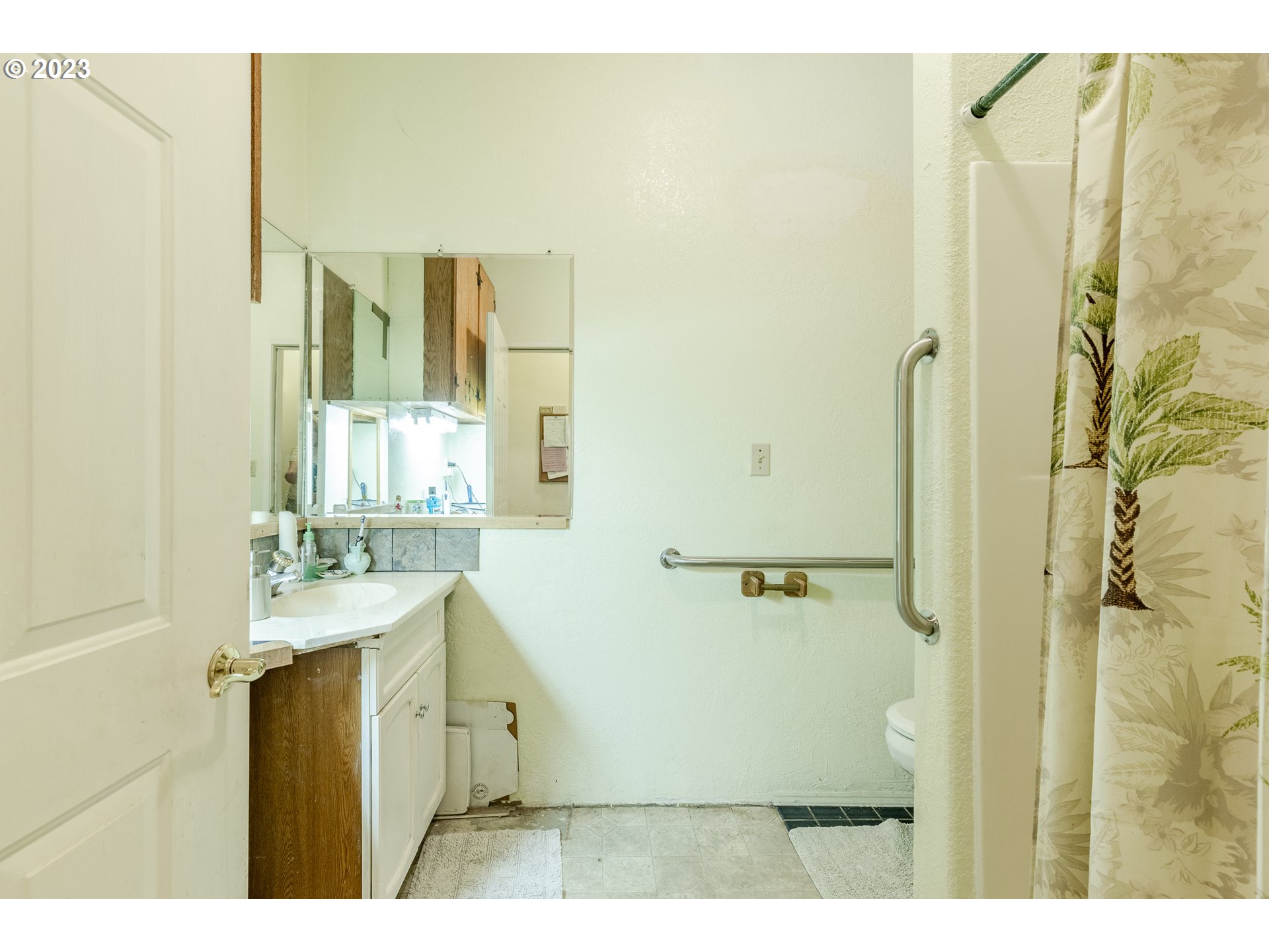 6585 Main Street Springfield, OR 97478 - Photo 28 of 30 a bathroom with a granite countertop sink a mirror and a shower