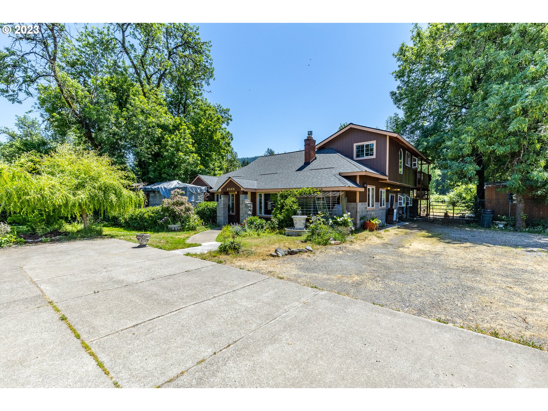 6585 Main Street Springfield, OR 97478 - Photo 10 of 30 a front view of a house next to a yard