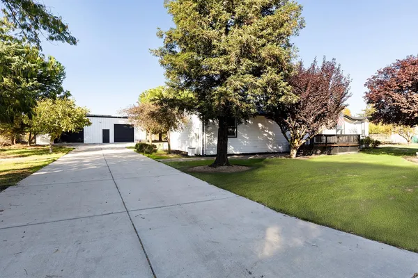 a front view of house with yard and green space