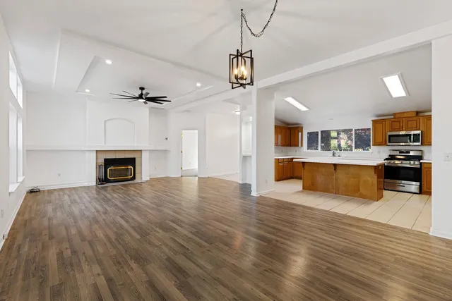 a kitchen with stainless steel appliances granite countertop wooden cabinets a stove top oven a sink and dishwasher