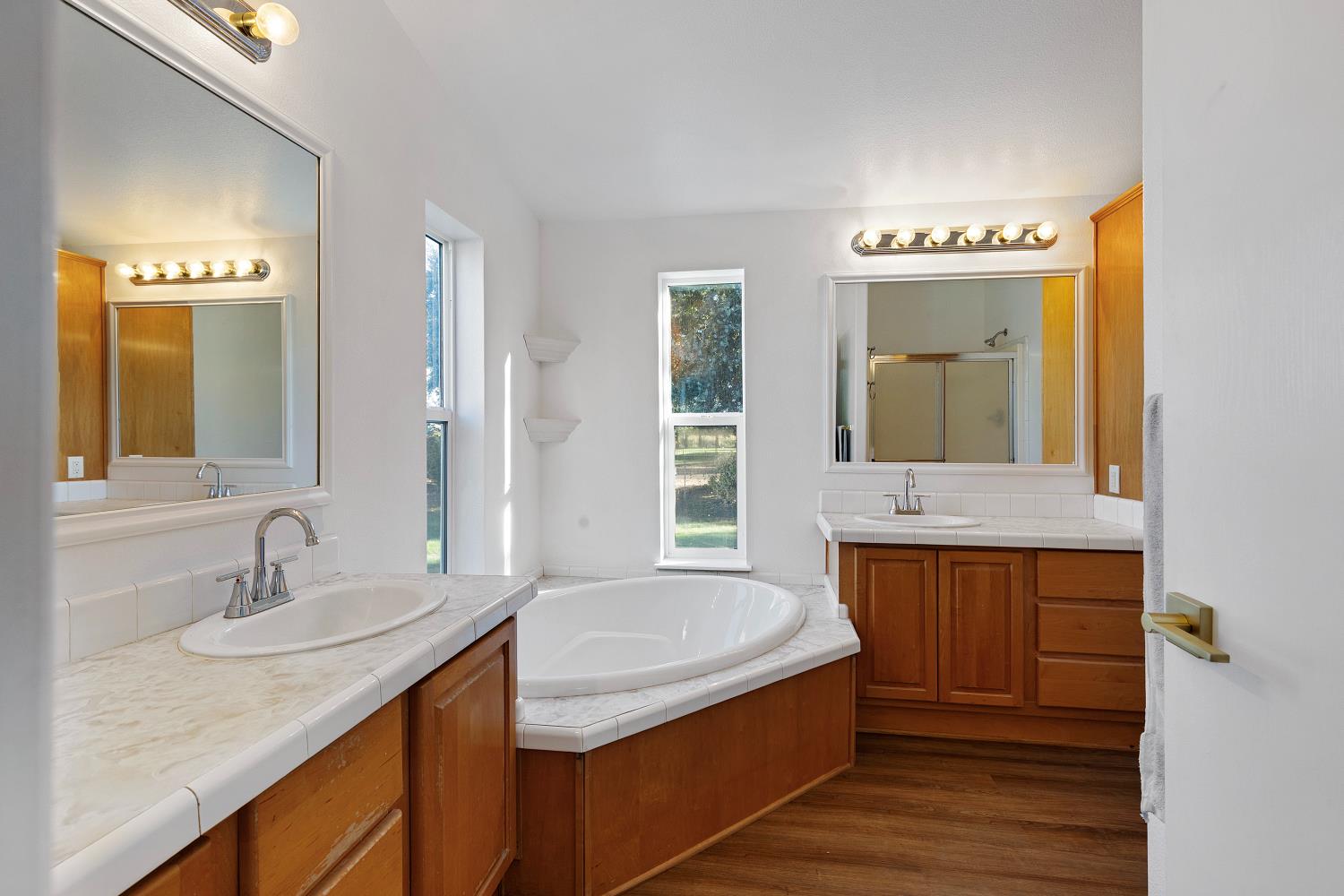 8181 West Kile Road Thornton, CA 95686 - Photo 27 of 65 a bathroom with a granite countertop sink and a mirror