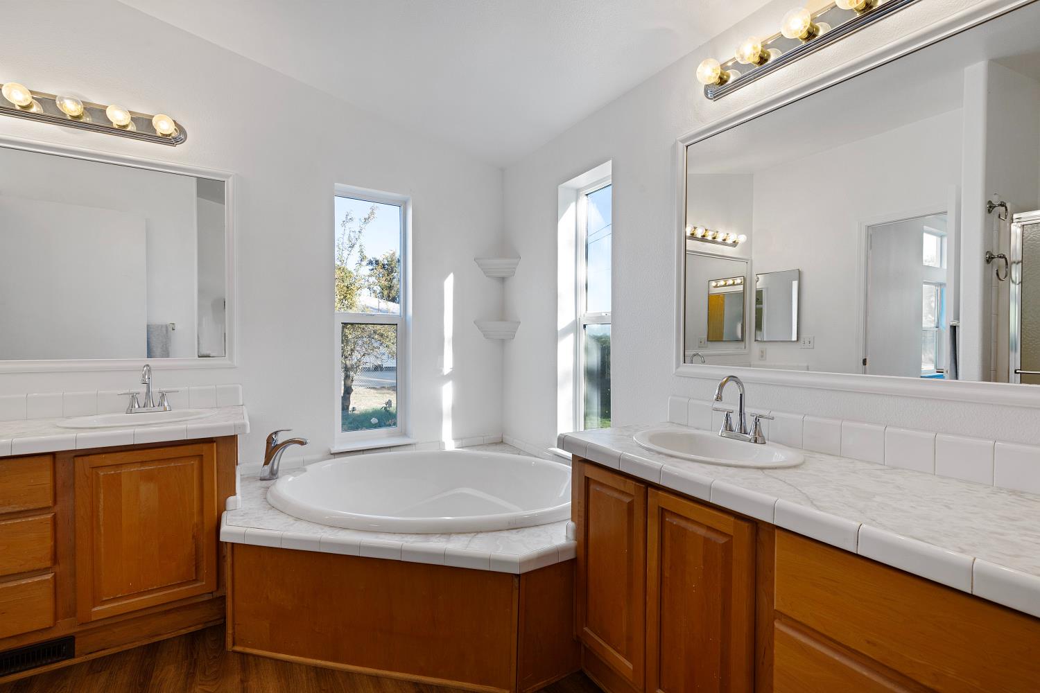8181 West Kile Road Thornton, CA 95686 - Photo 28 of 65 a bathroom with a granite countertop sink and a mirror