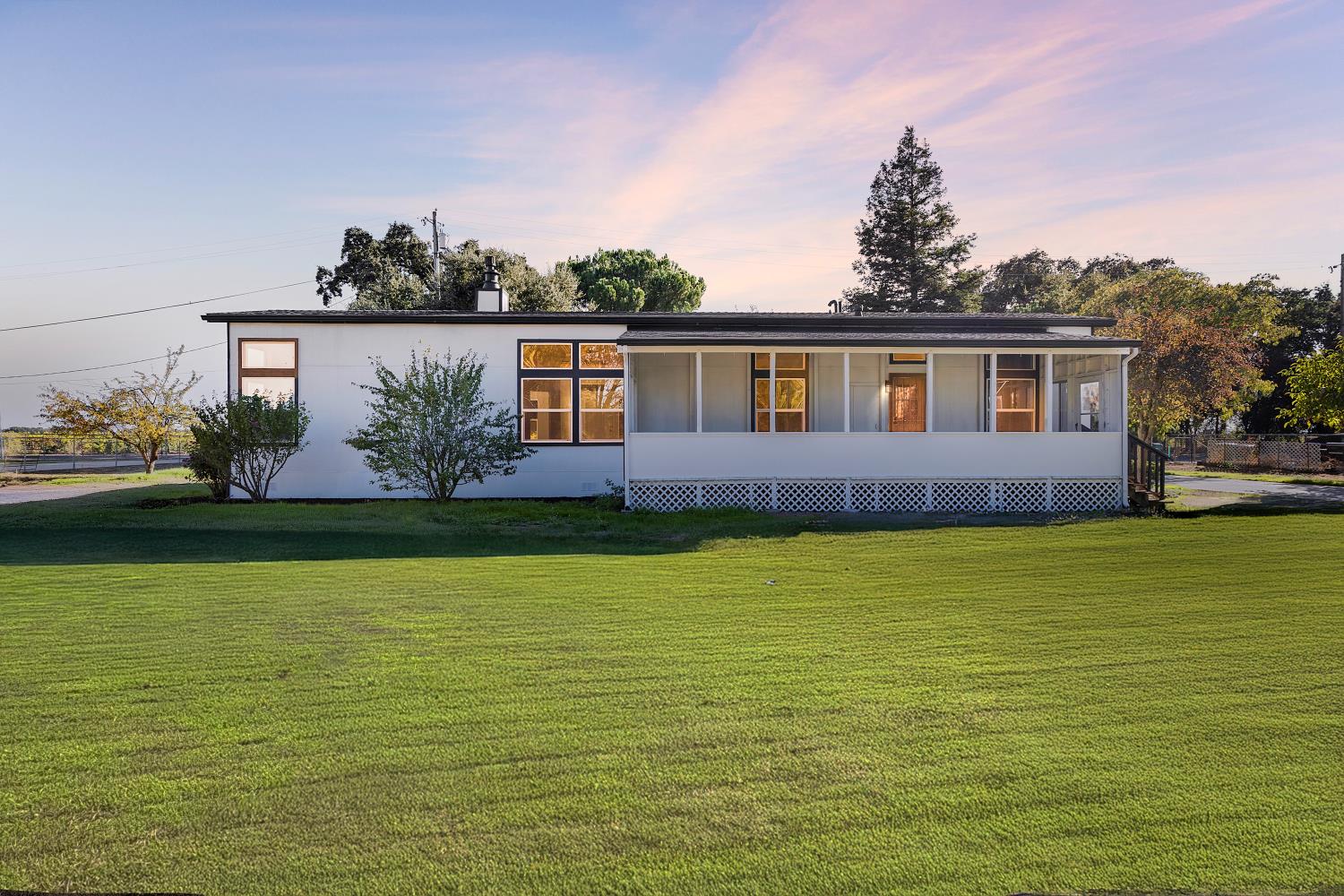 8181 West Kile Road Thornton, CA 95686 - Photo 36 of 65 a front view of a house with a yard