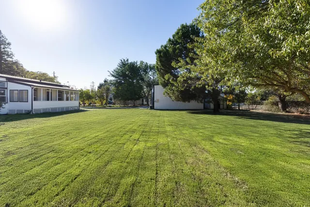 a swimming pool with outdoor seating and yard