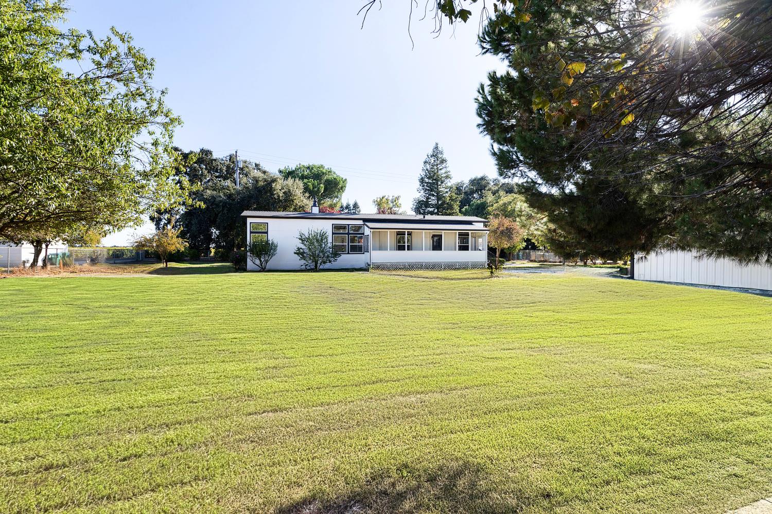 8181 West Kile Road Thornton, CA 95686 - Photo 40 of 65 a view of a swimming pool with an outdoor space and seating area
