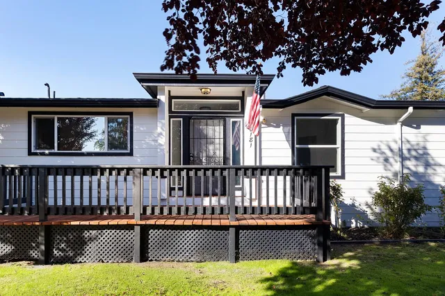 a balcony with wooden floor and stairs