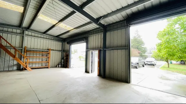 an aerial view of a house with a garden and lake view