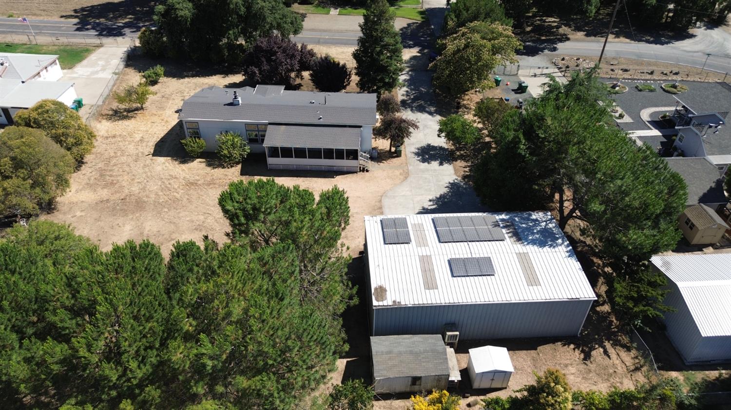 8181 West Kile Road Thornton, CA 95686 - Photo 58 of 65 an aerial view of a house with swimming pool and large trees