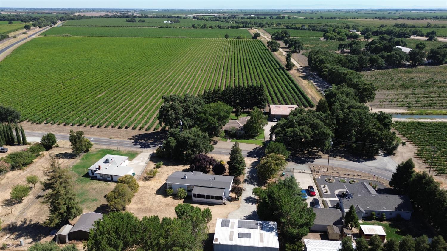 8181 West Kile Road Thornton, CA 95686 - Photo 61 of 65 an aerial view of a house with a garden and lake view