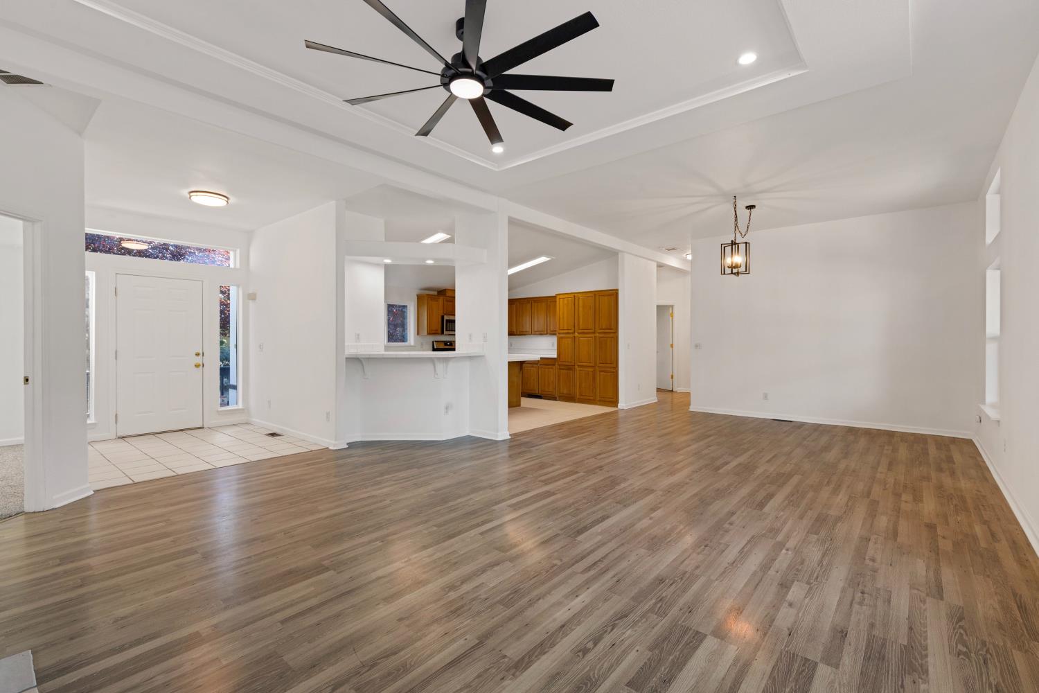 8181 West Kile Road Thornton, CA 95686 - Photo 10 of 65 a view of an empty room with wooden floor and a ceiling fan