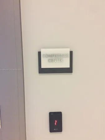 a dining room with furniture and a flat screen tv