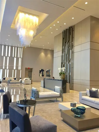 a living room with fireplace furniture and a large window