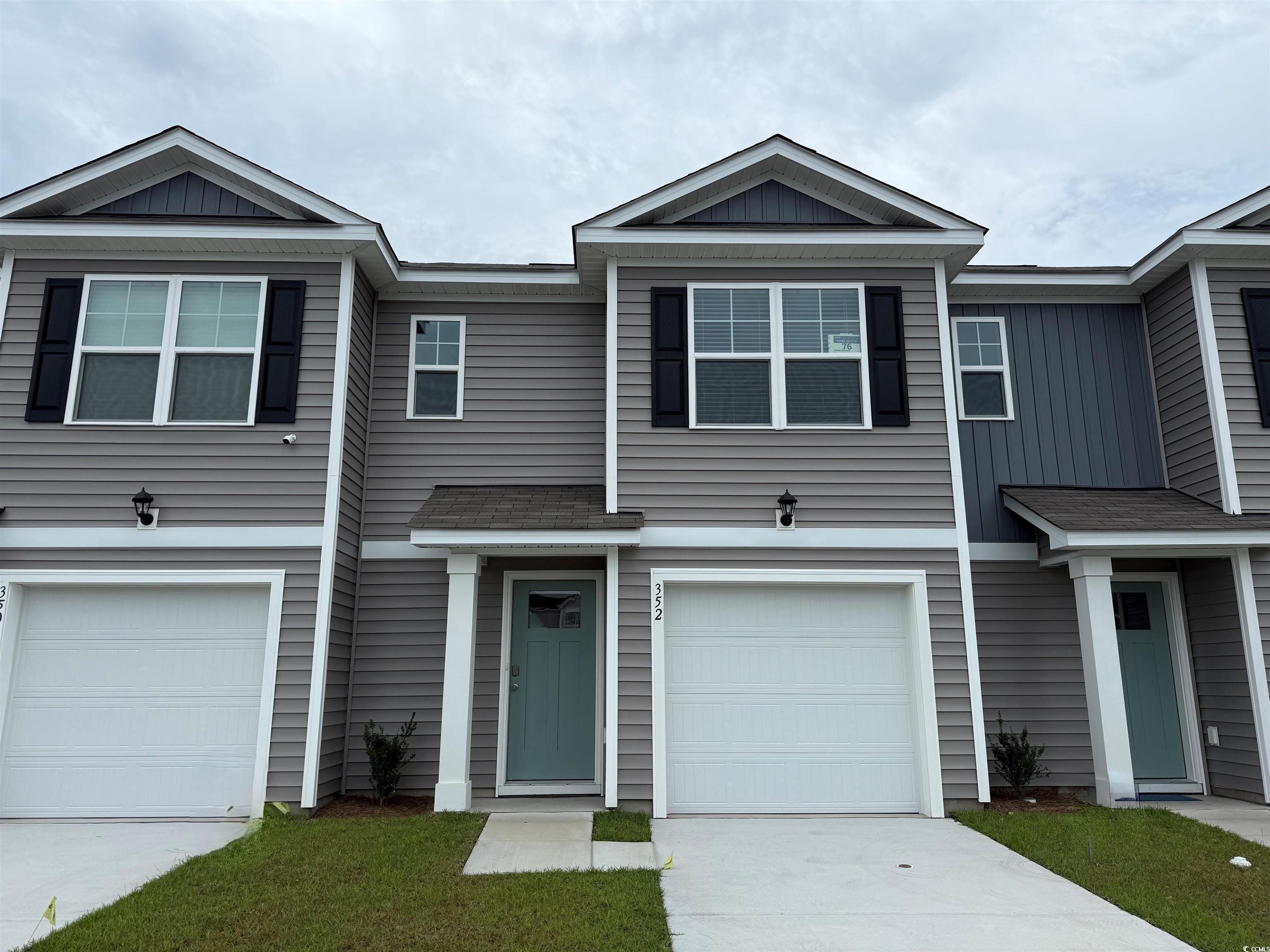 352 Bayou Loop, Unit LOT 76 Surfside Beach, SC 29575 - Photo 1 of 17 View of front of house with an attached garage, bo