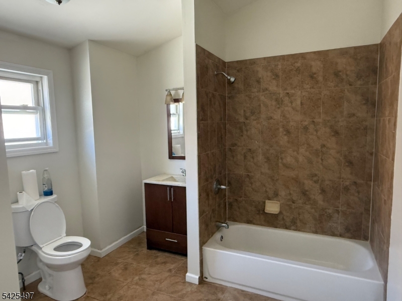 74 Spring Street Bloomfield, NJ 07003 - Photo 3 of 9 a bathroom with a toilet and a bathtub