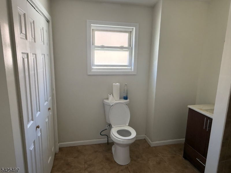 74 Spring Street Bloomfield, NJ 07003 - Photo 4 of 9 a white toilet sitting next to a bathroom sink