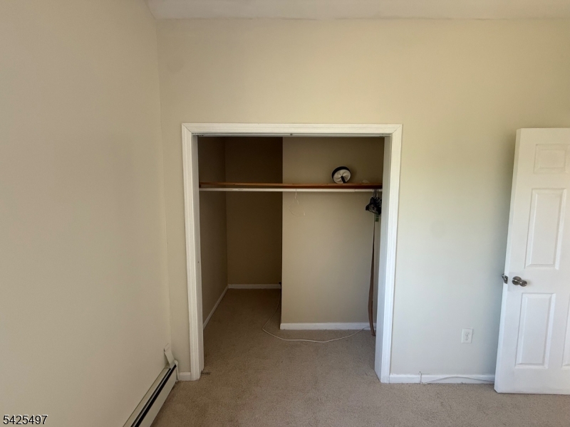 74 Spring Street Bloomfield, NJ 07003 - Photo 6 of 9 a view of walk in closet with clothes
