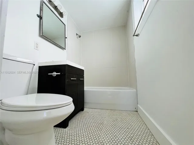 a bathroom with a toilet a sink and bathtub