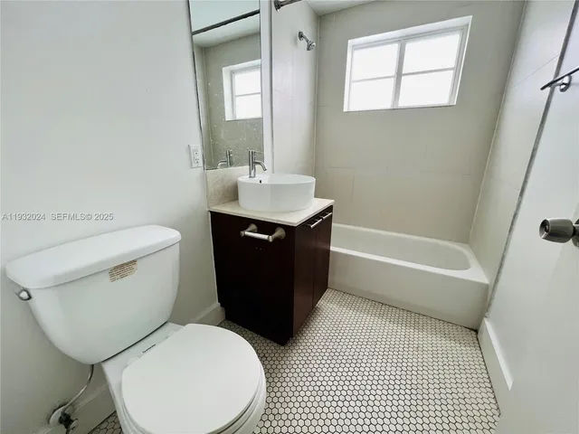 a bathroom with a toilet a sink and bathtub