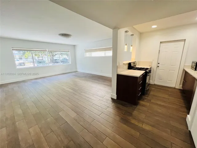 a room with wooden floor and furniture