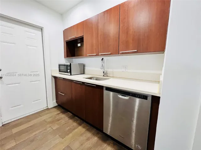 a kitchen with a sink and a microwave