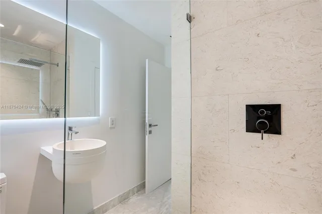 a bathroom with a shower and a sink