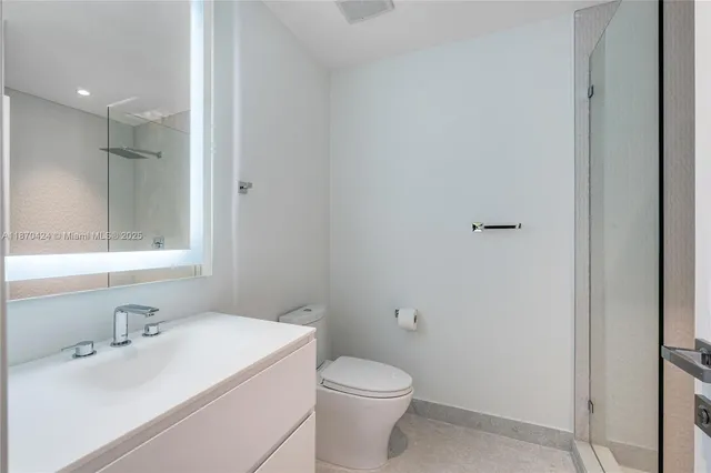 a bathroom with a shower sink and mirror