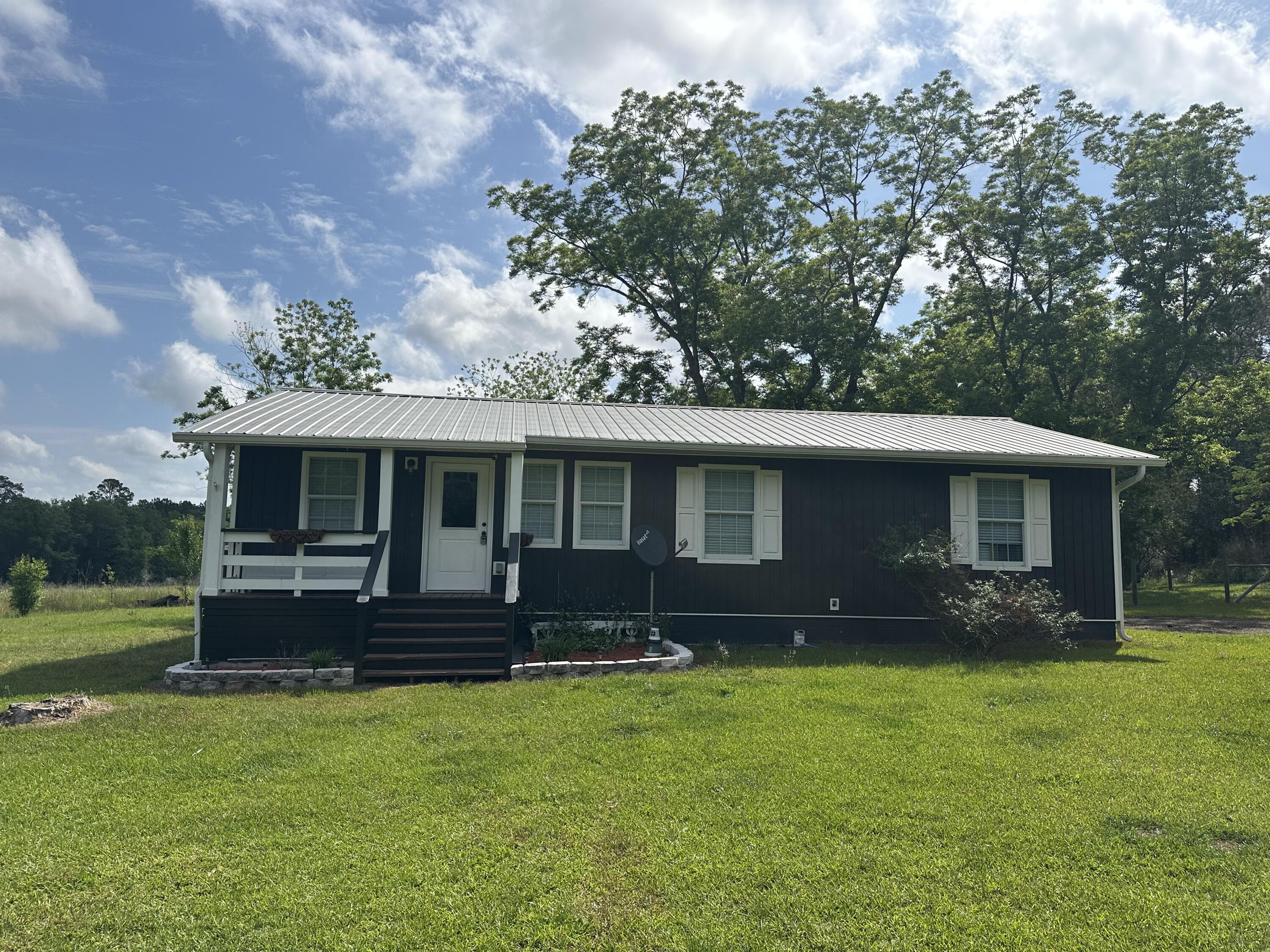 a front view of a house with a garden