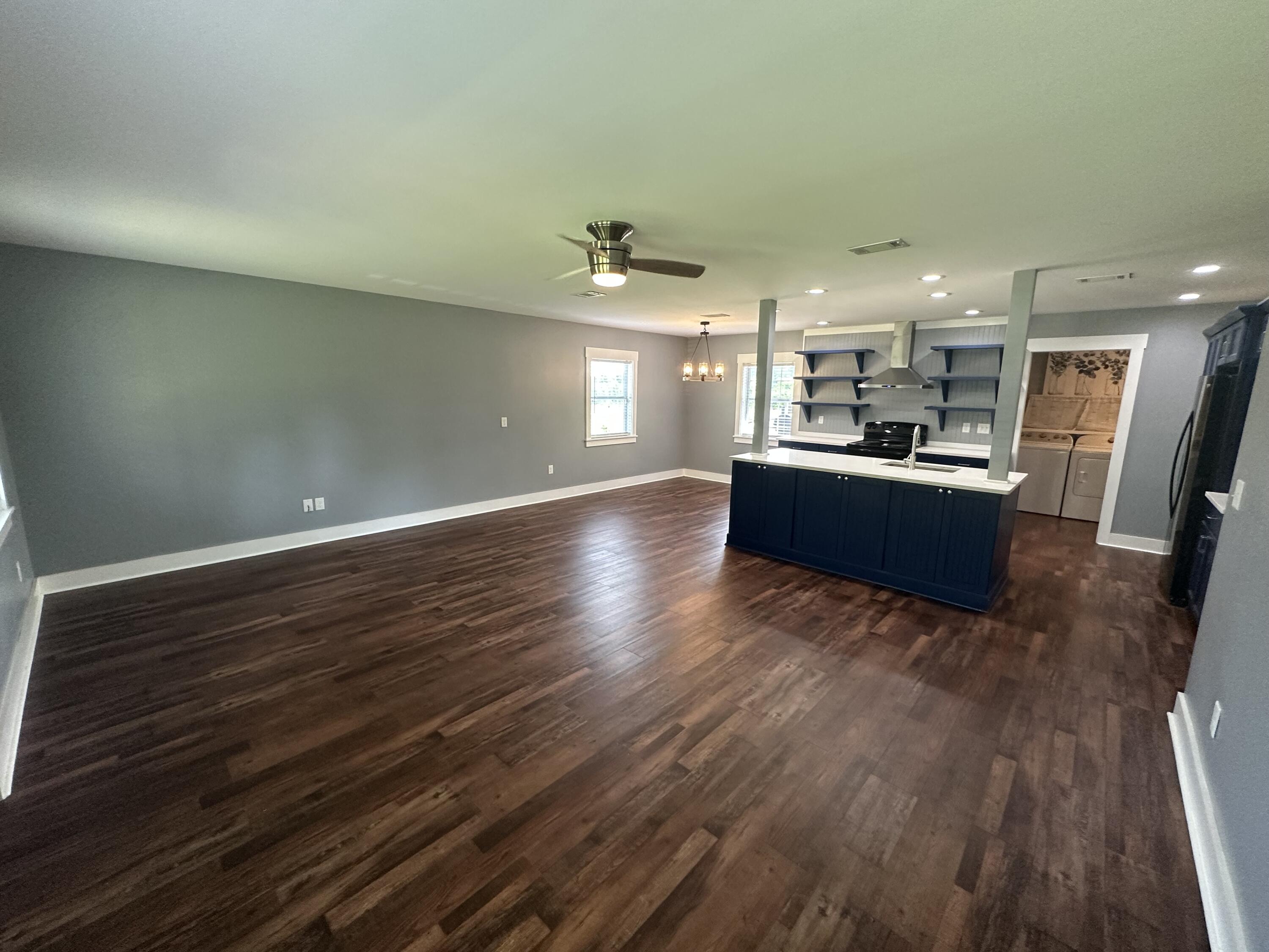 10712 Highway 331 DeFuniak Springs, FL 32433 - Photo 18 of 56 a living room with hard wood floors and kitchen