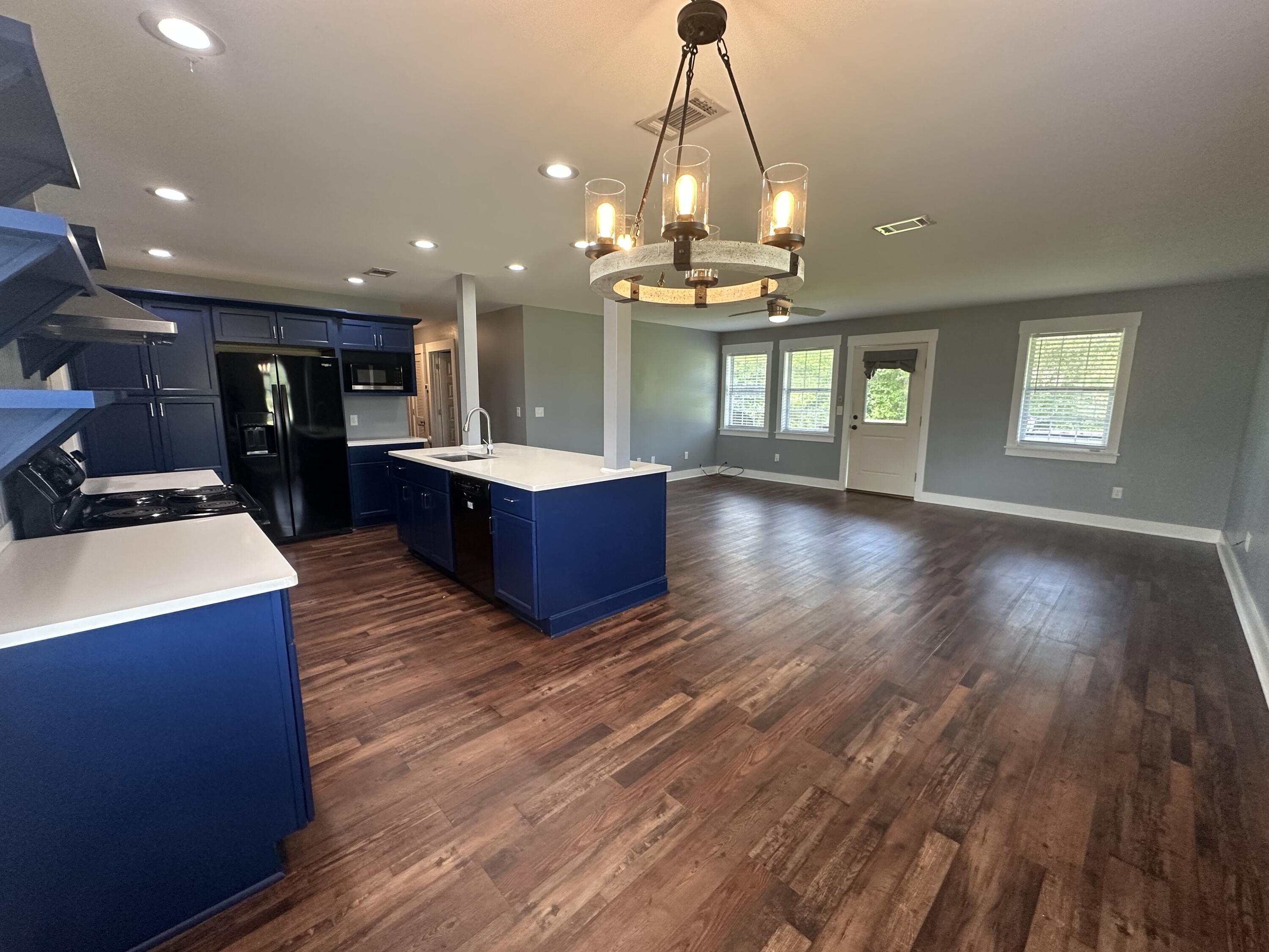 10712 Highway 331 DeFuniak Springs, FL 32433 - Photo 20 of 56 a view of a room with wooden floor and kitchen