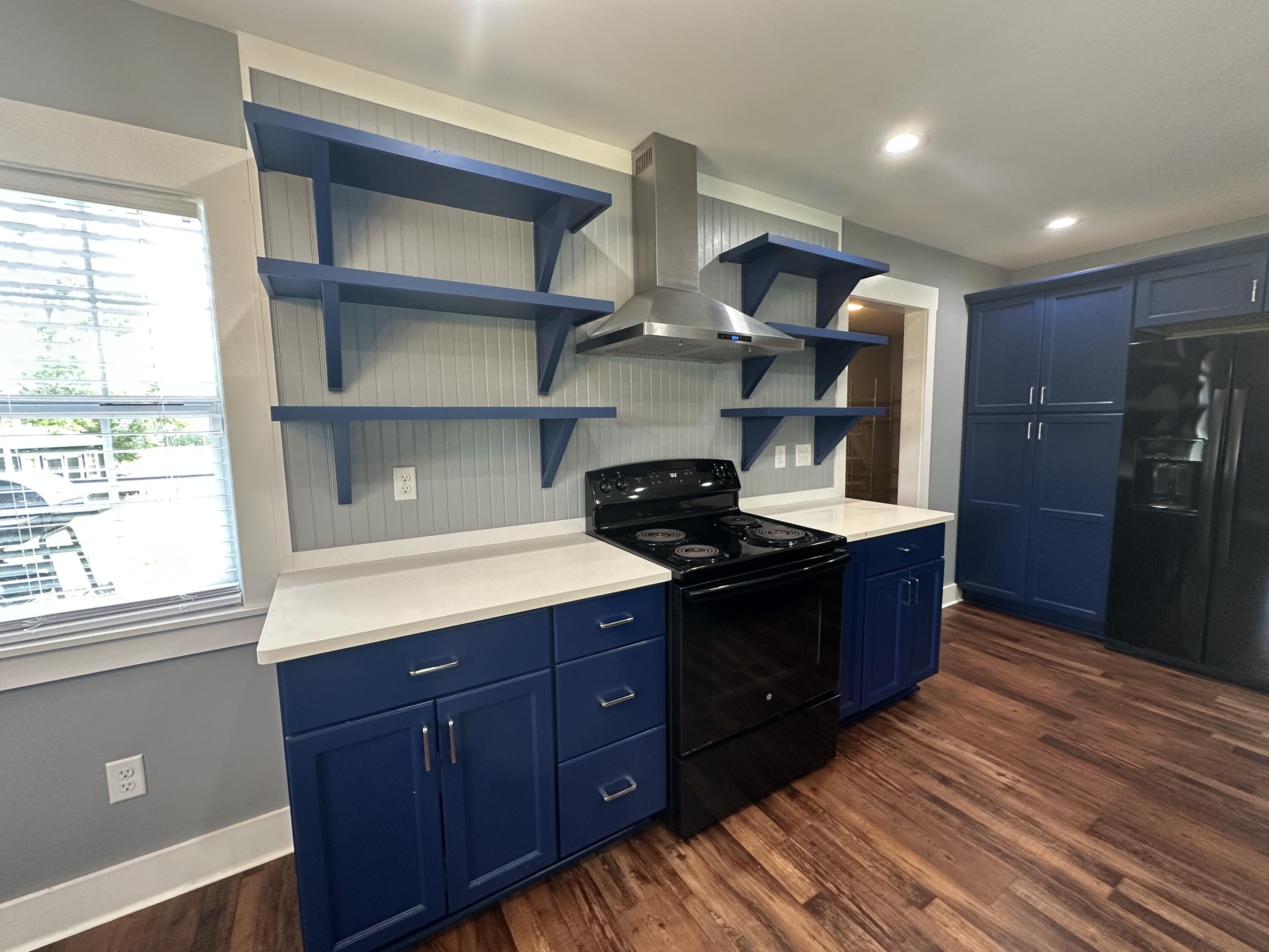 10712 Highway 331 DeFuniak Springs, FL 32433 - Photo 21 of 56 a kitchen with stainless steel appliances granite countertop a stove a sink and a refrigerator