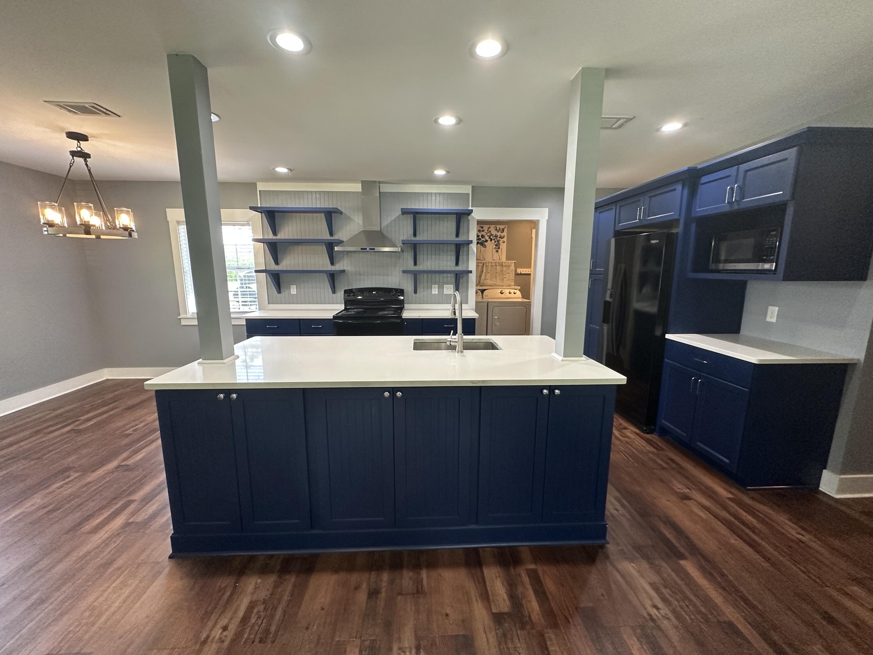 10712 Highway 331 DeFuniak Springs, FL 32433 - Photo 23 of 56 a large kitchen with wooden floors and a sink