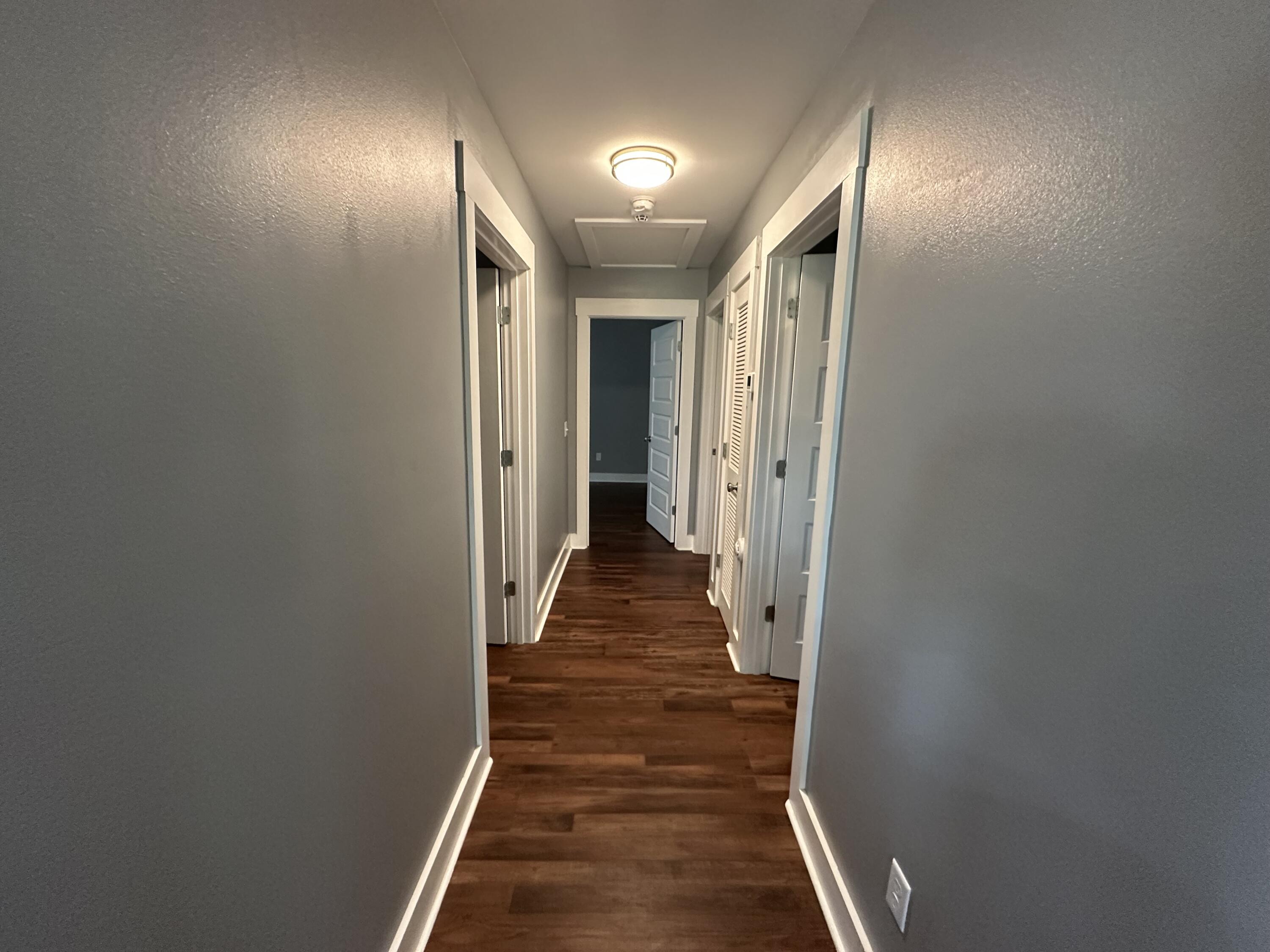 10712 Highway 331 DeFuniak Springs, FL 32433 - Photo 26 of 56 a view of a hallway with wooden floor and staircase