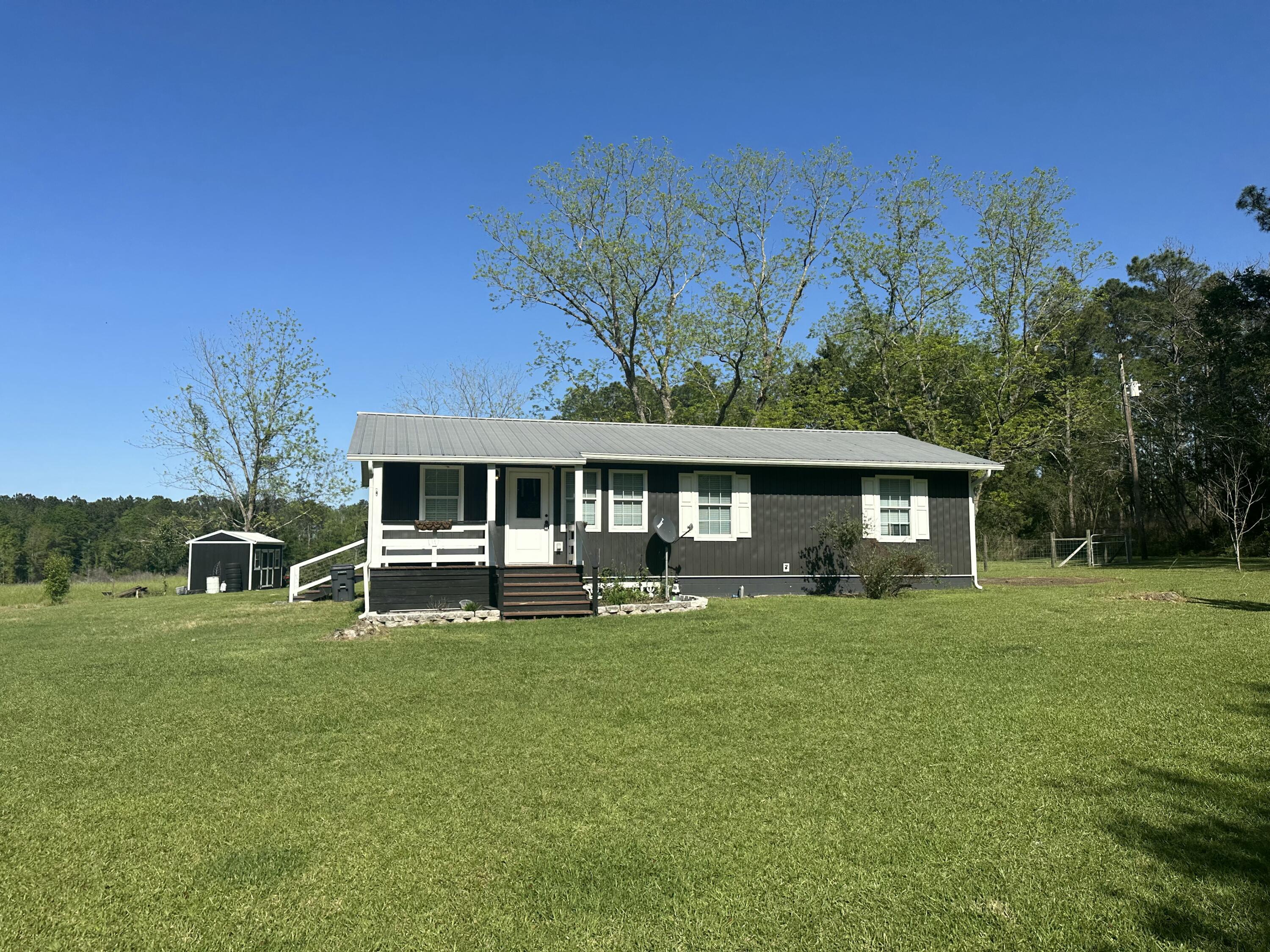 10712 Highway 331 DeFuniak Springs, FL 32433 - Photo 3 of 56 a front view of a house with garden