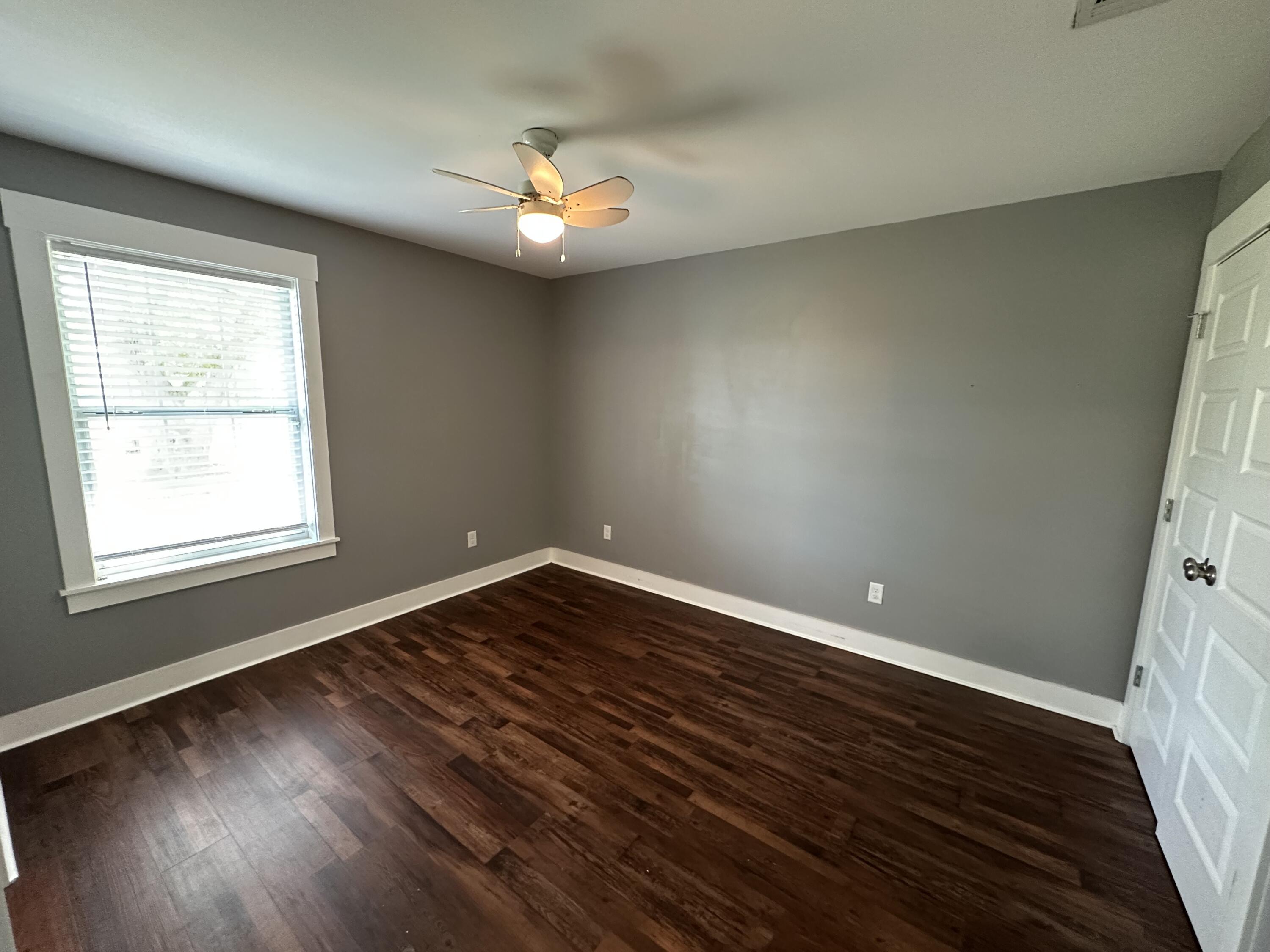 10712 Highway 331 DeFuniak Springs, FL 32433 - Photo 32 of 56 a view of an empty room with wooden floor and a window