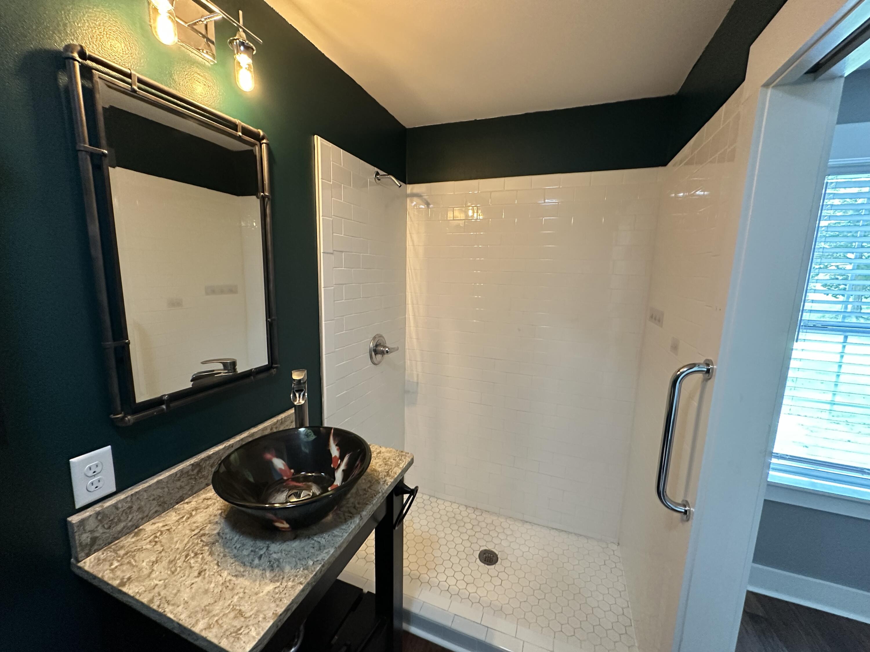 10712 Highway 331 DeFuniak Springs, FL 32433 - Photo 37 of 56 a bathroom with a granite countertop sink and a mirror