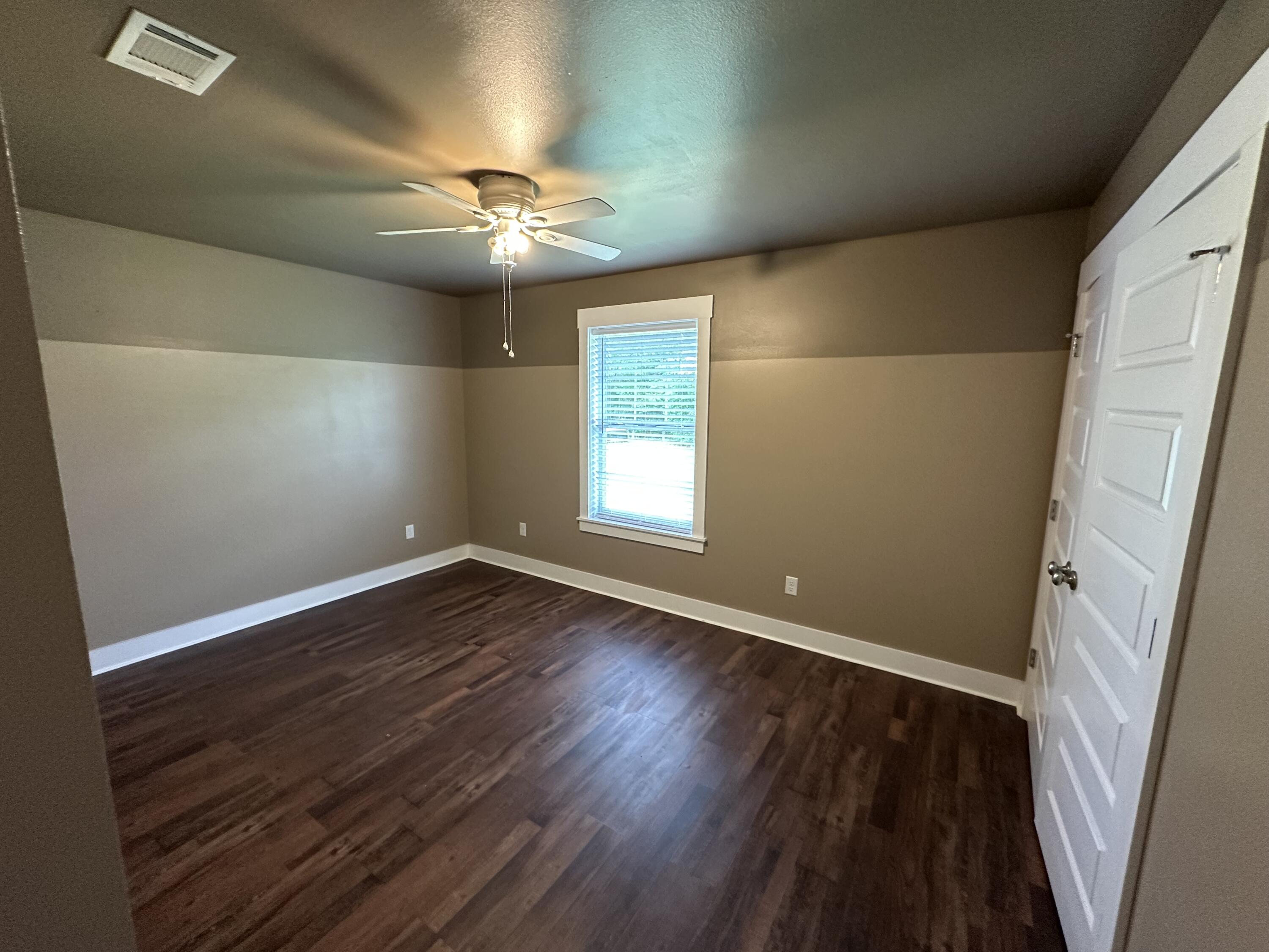 10712 Highway 331 DeFuniak Springs, FL 32433 - Photo 39 of 56 wooden floor in an empty room with a window
