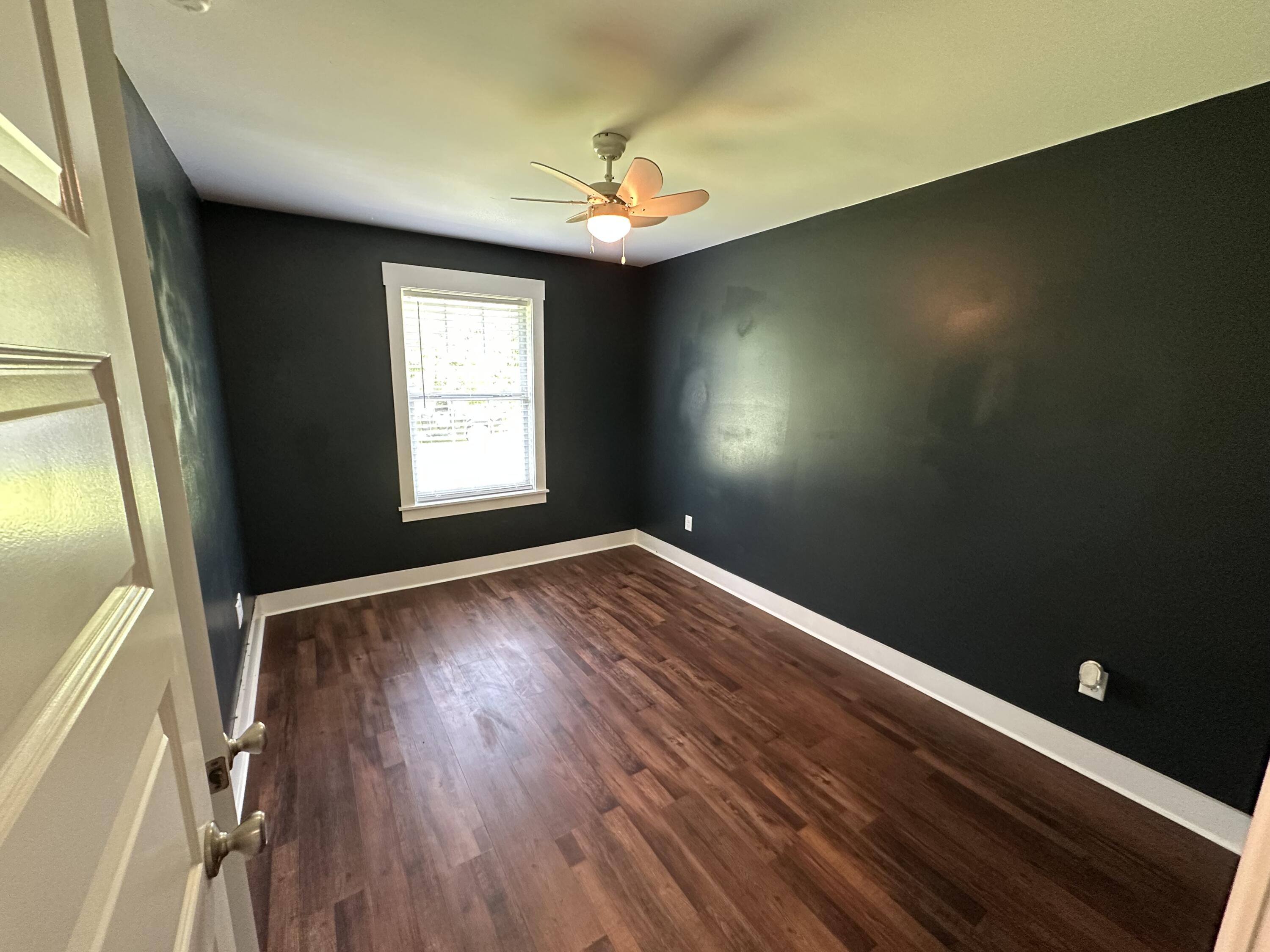 10712 Highway 331 DeFuniak Springs, FL 32433 - Photo 41 of 56 an empty room with wooden floor and windows