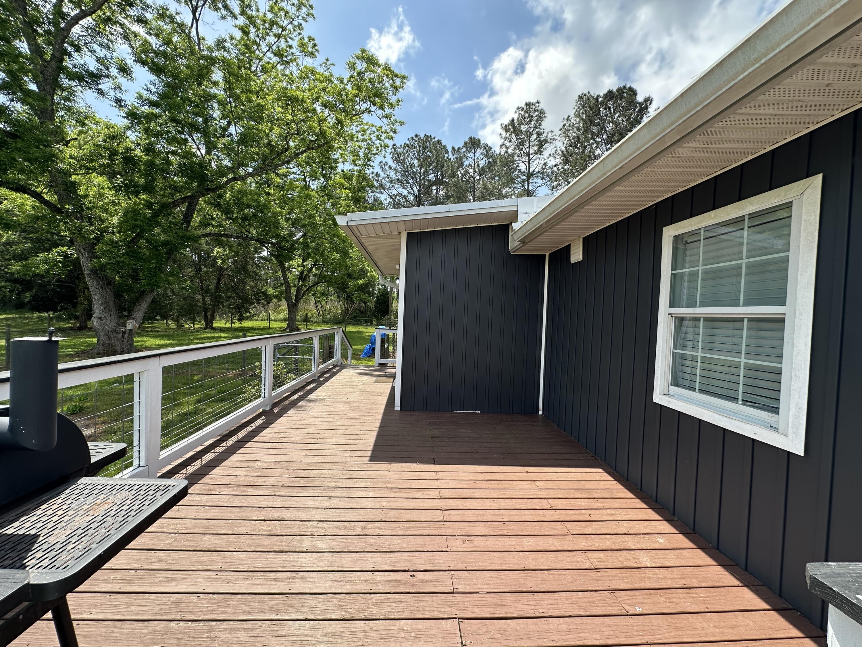 10712 Highway 331 DeFuniak Springs, FL 32433 - Photo 44 of 56 a view of deck with mountain view and wooden floor