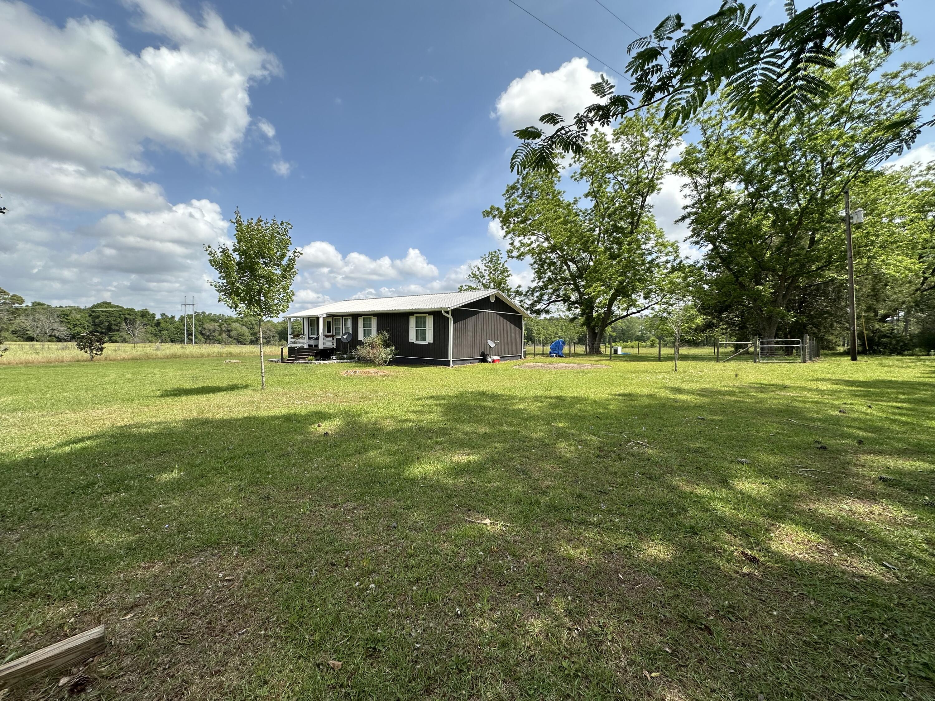 10712 Highway 331 DeFuniak Springs, FL 32433 - Photo 5 of 56 a view of yard with swimming pool and green space