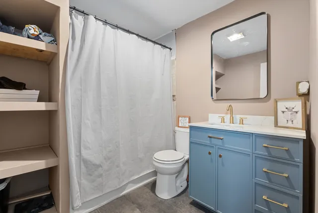 a bathroom with a sink a toilet and a mirror