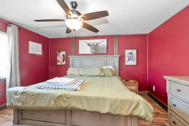 a bedroom with a bed and a dresser