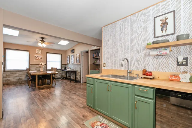 a kitchen with a sink cabinets and wooden floor