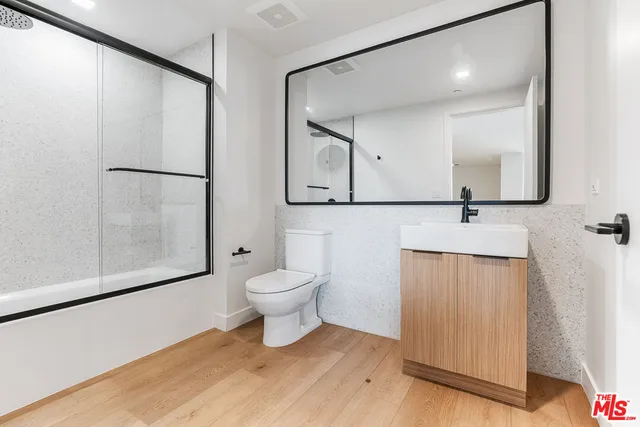 a bathroom with a toilet sink and shower