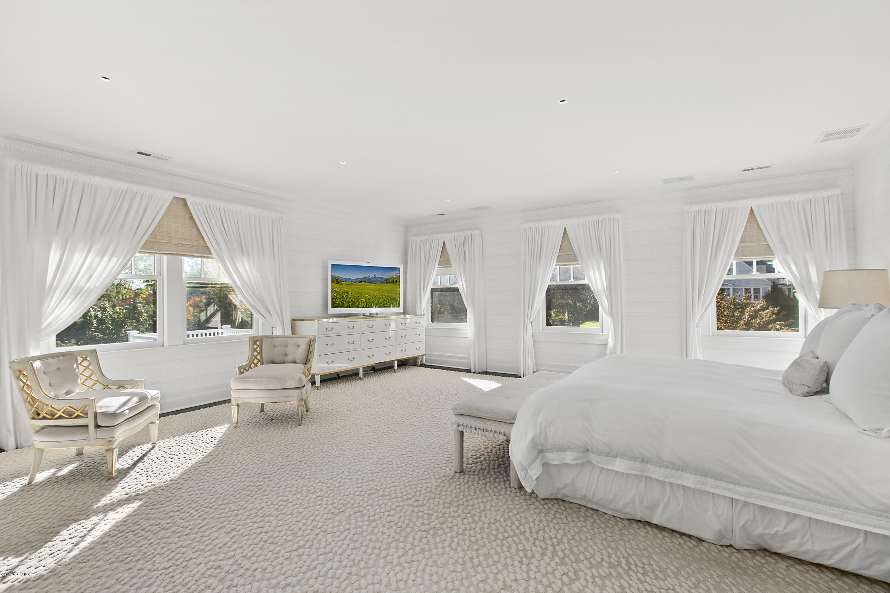 133 Otter Rock Drive Greenwich, CT 06830 - Photo 11 of 17 a bedroom with a bed and large window