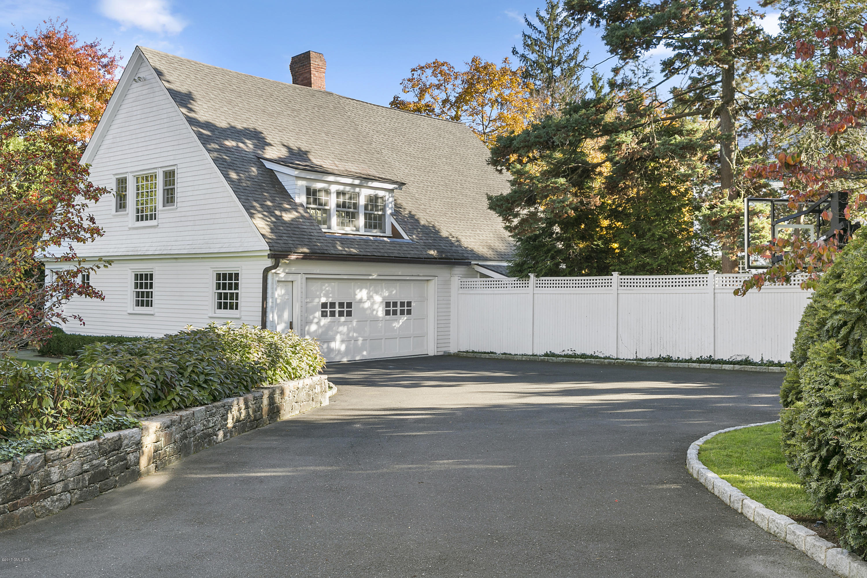 133 Otter Rock Drive Greenwich, CT 06830 - Photo 17 of 17 a front view of a house with a yard and garage