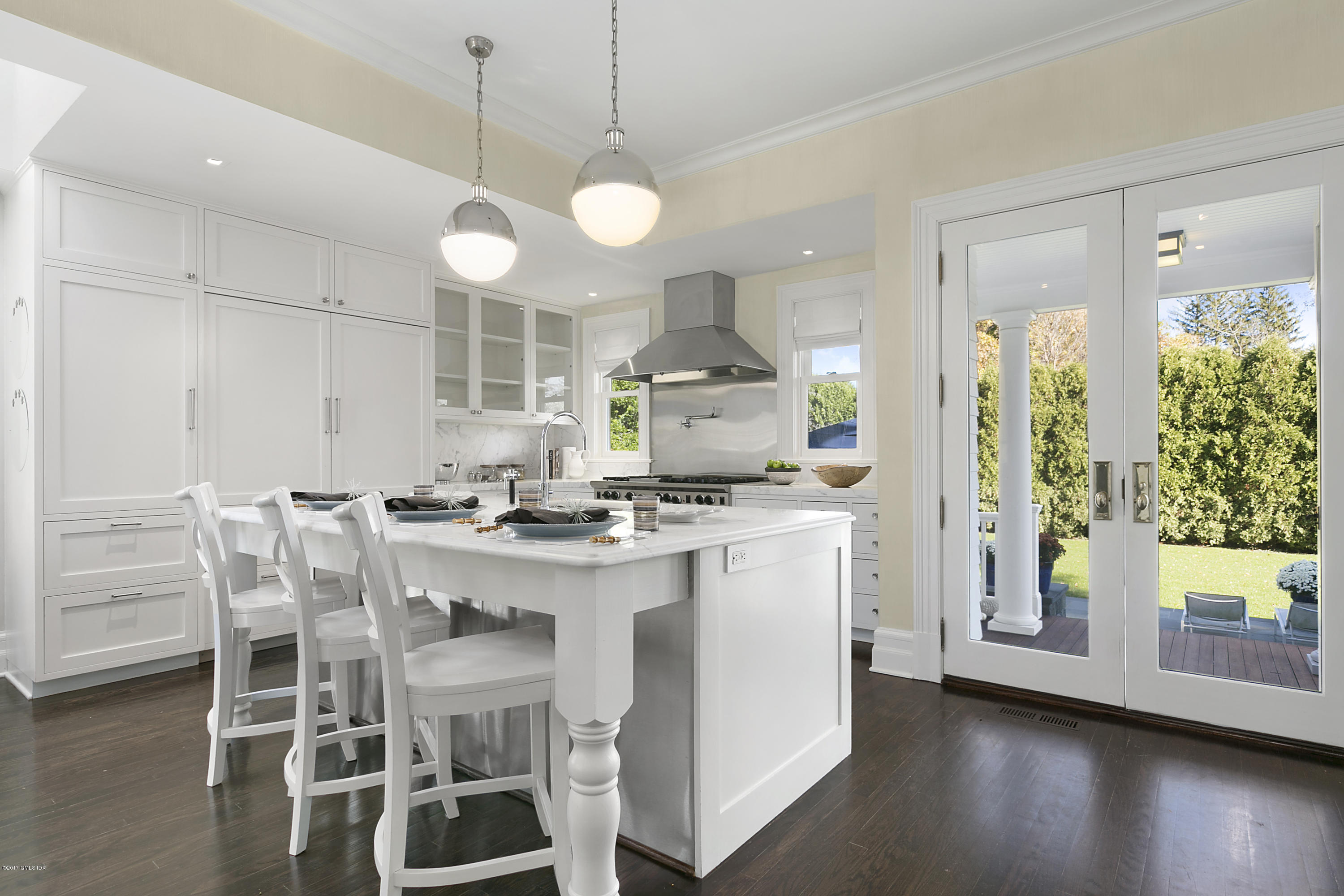 133 Otter Rock Drive Greenwich, CT 06830 - Photo 8 of 17 a kitchen with stainless steel appliances a dining table chairs and wooden floor