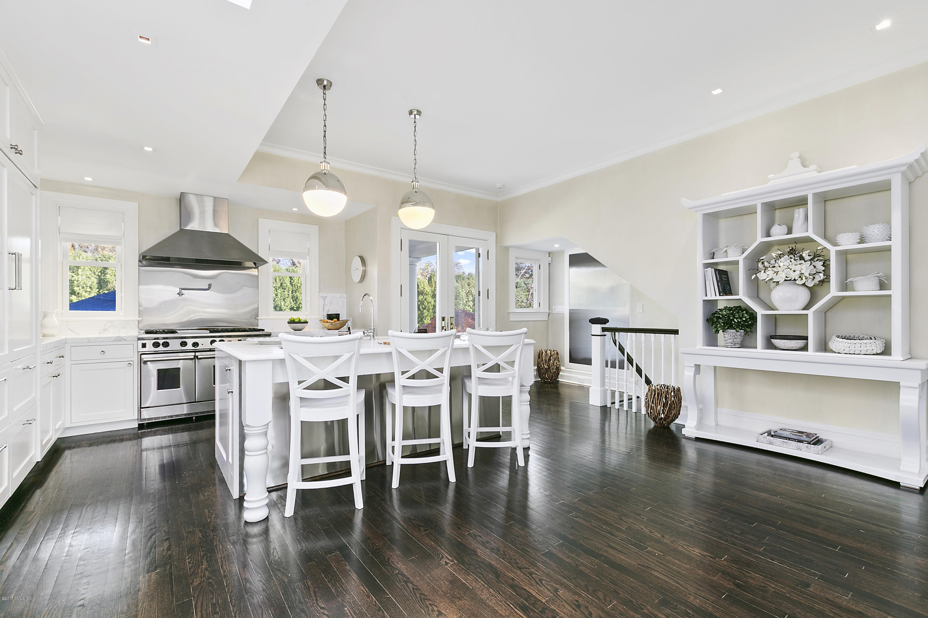 133 Otter Rock Drive Greenwich, CT 06830 - Photo 9 of 17 a kitchen with a dining table chairs stainless steel appliances and cabinets