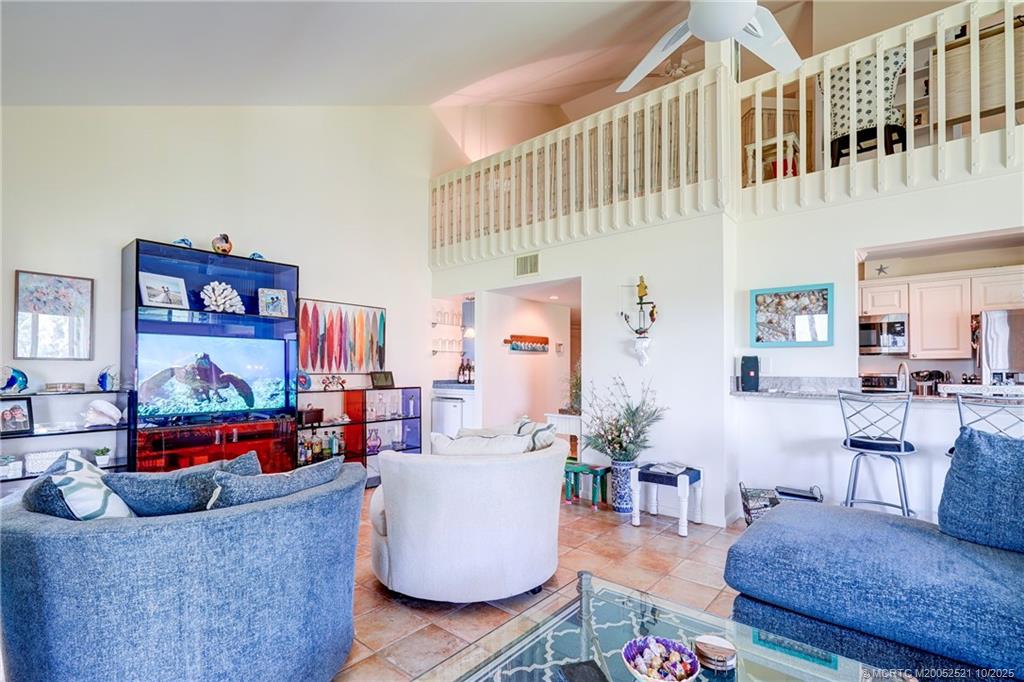 233 Northeast Edgewater Drive, Unit 201 Stuart, FL 34996 - Photo 21 of 64 a living room with furniture and a rug