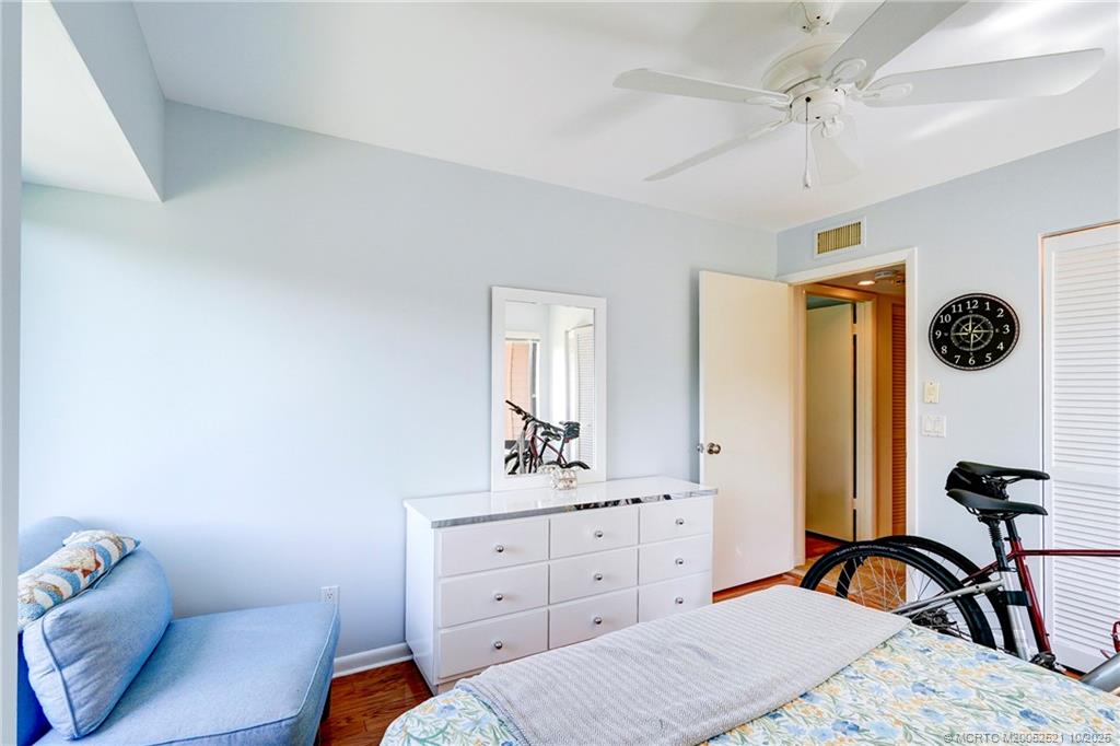233 Northeast Edgewater Drive, Unit 201 Stuart, FL 34996 - Photo 33 of 64 a bedroom with a bed and a dresser in it