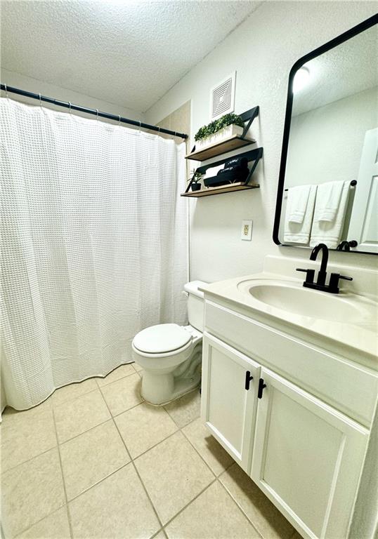 250 Little Street, Unit D107 Athens, GA 30605 - Photo 11 of 20 a bathroom with a sink a toilet a mirror and shower